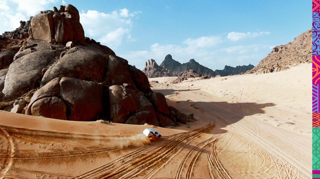 Aerial view of an SUV driving in the desert