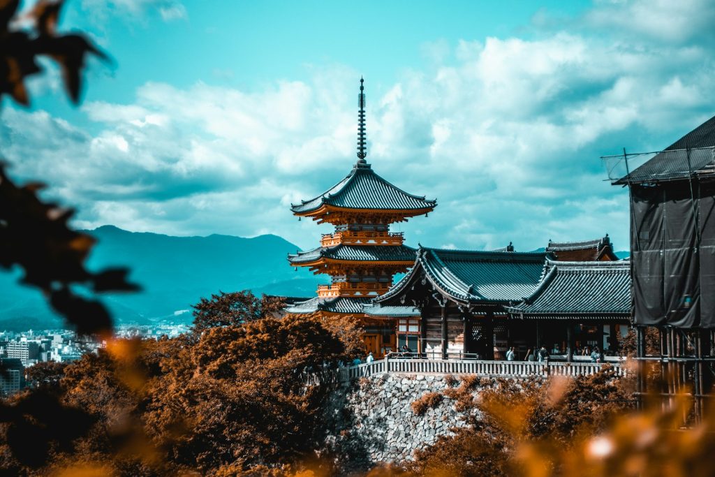 people near pagoda under white and blue sky kyoto japan