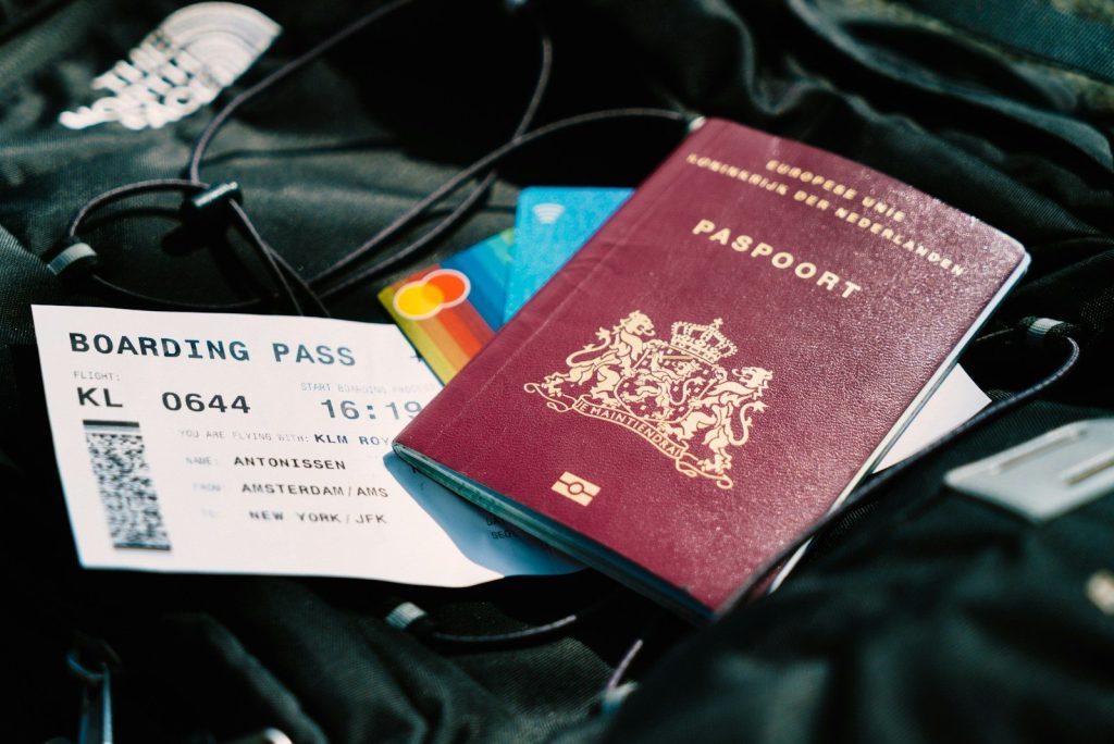 a passport and a boarding pass are on a bag paspoort handige reisgadgets